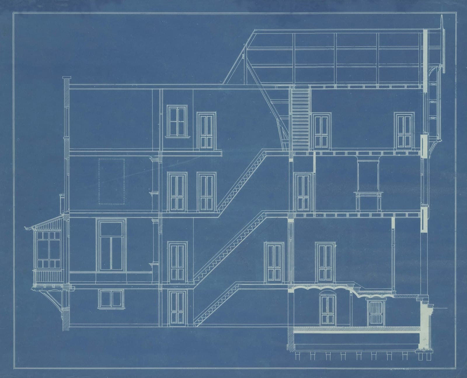 An architectural blueprint of a multi-storey building, dense with dimension lines and annotations.